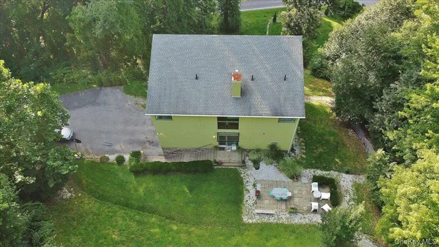 an aerial view of a house with a yard