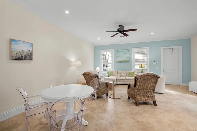 a living room with furniture a ceiling fan and a rug