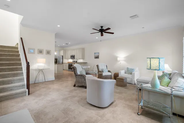 a living room with furniture a rug and white walls