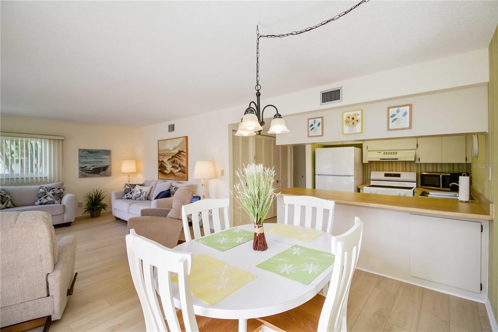 5476 Swift Road, Unit 19 Sarasota, FL 34231 - Photo 11 of 34 a view of a dining room with furniture window and wooden floor