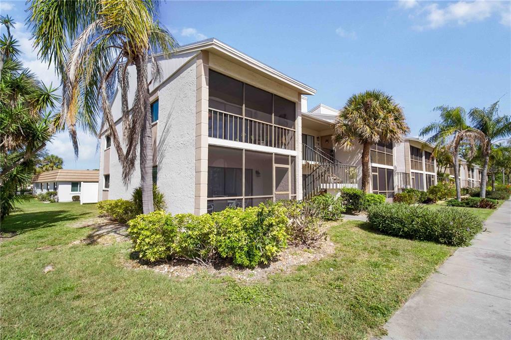 5476 Swift Road, Unit 19 Sarasota, FL 34231 - Photo 2 of 34 a front view of a house with a yard