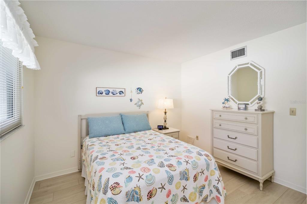 5476 Swift Road, Unit 19 Sarasota, FL 34231 - Photo 21 of 34 a bedroom with a bed and a dresser