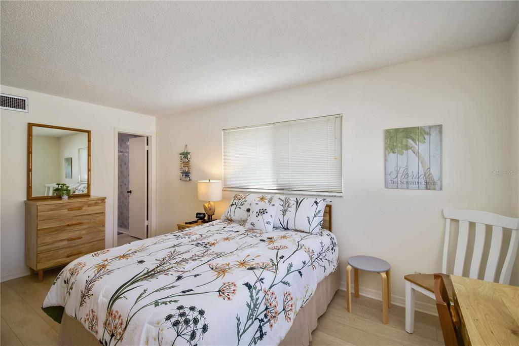 5476 Swift Road, Unit 19 Sarasota, FL 34231 - Photo 23 of 34 a bedroom with a bed and a dresser