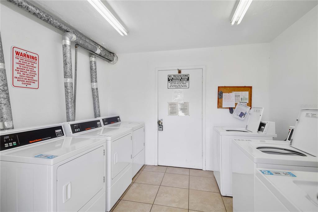 5476 Swift Road, Unit 19 Sarasota, FL 34231 - Photo 28 of 34 a bathroom with a sink and a washing machine