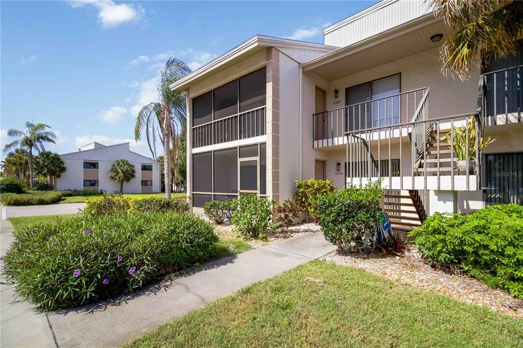5476 Swift Road, Unit 19 Sarasota, FL 34231 - Photo 3 of 34 a front view of a house with a yard
