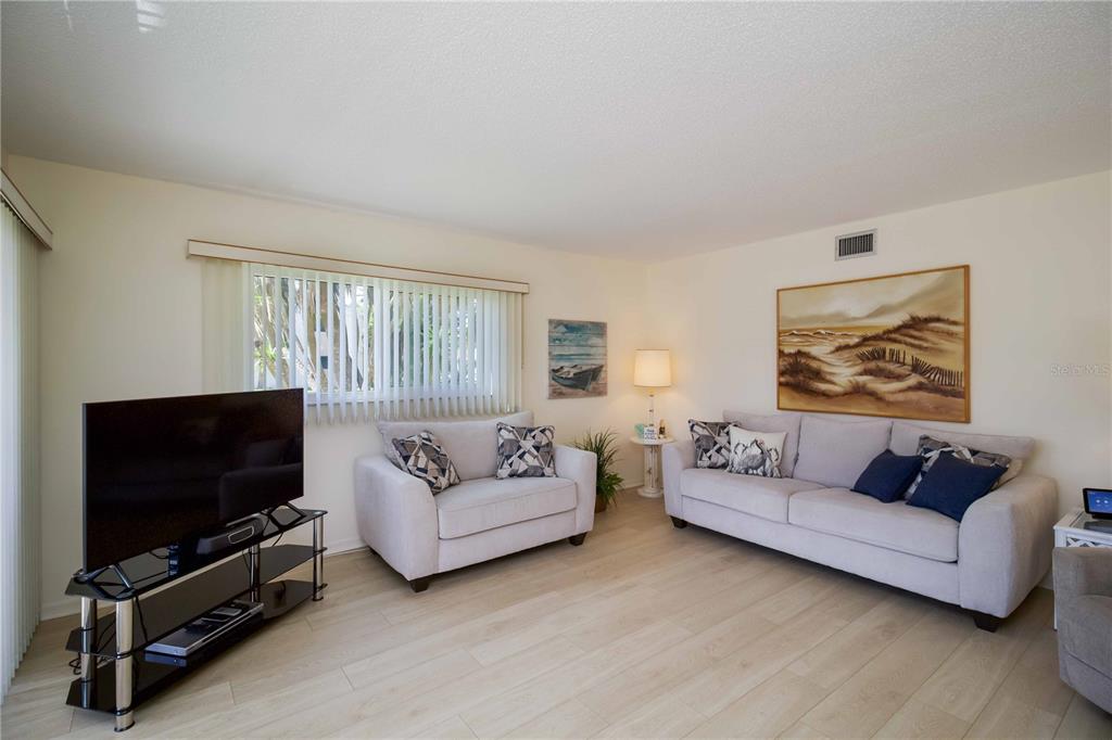 5476 Swift Road, Unit 19 Sarasota, FL 34231 - Photo 5 of 34 a living room with furniture and a flat screen tv