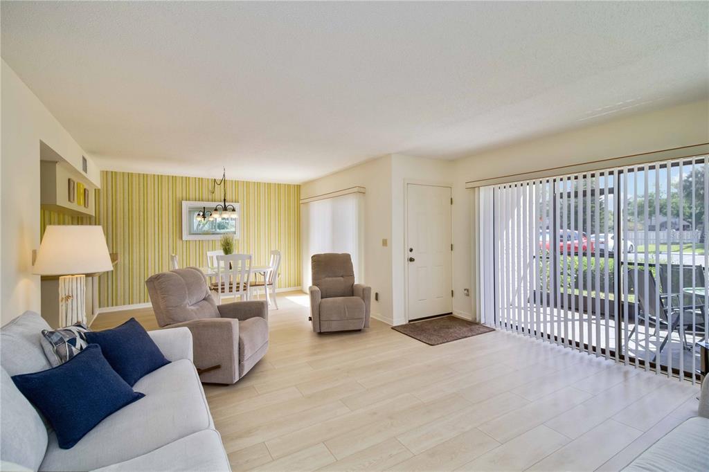 5476 Swift Road, Unit 19 Sarasota, FL 34231 - Photo 7 of 34 a living room with furniture and a lamp