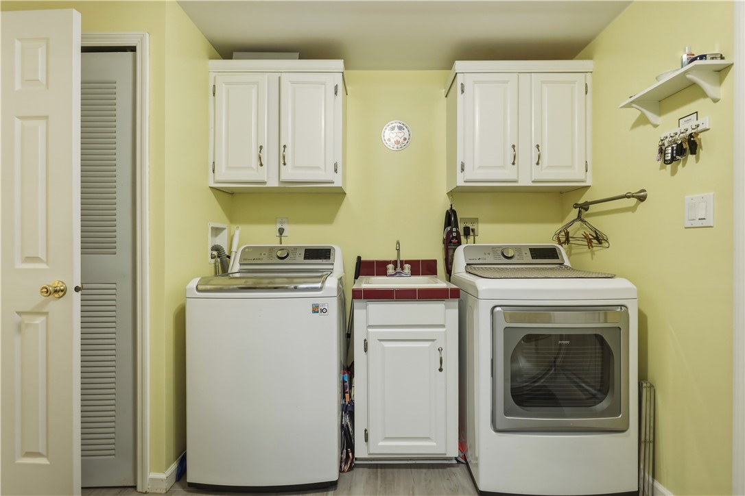136 Rocking Chair Road Big Flats, NY 14845 - Photo 26 of 38 Laundry with storage and half bath
