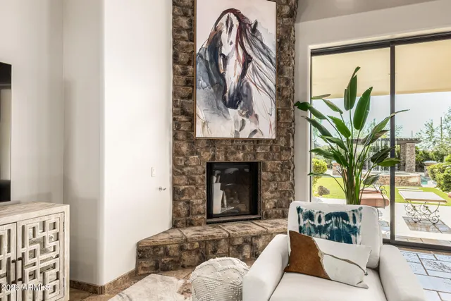 a dining room with furniture and large windows