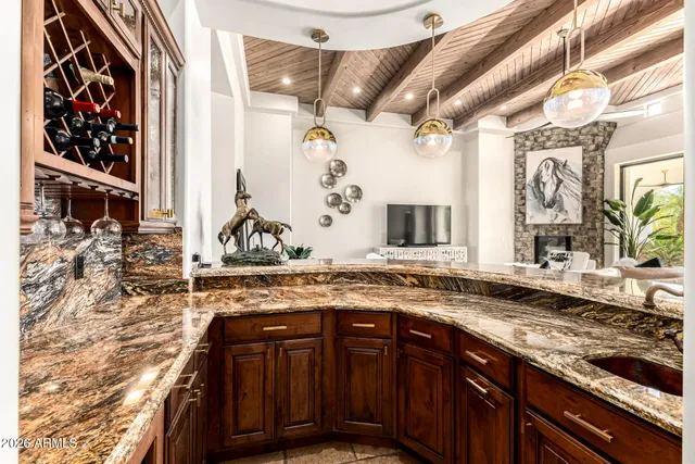 a bathroom with a granite countertop sink a toilet and a mirror