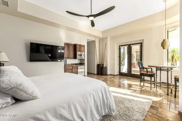 a bedroom with a bed and a flat screen tv