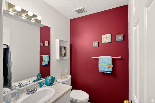 161 West 950 South, Unit Q1 St. George, UT 84770 - Photo 21 of 37 Half bathroom with vanity and a textured ceiling