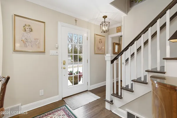 a dining room with furniture a chandelier and wooden floor