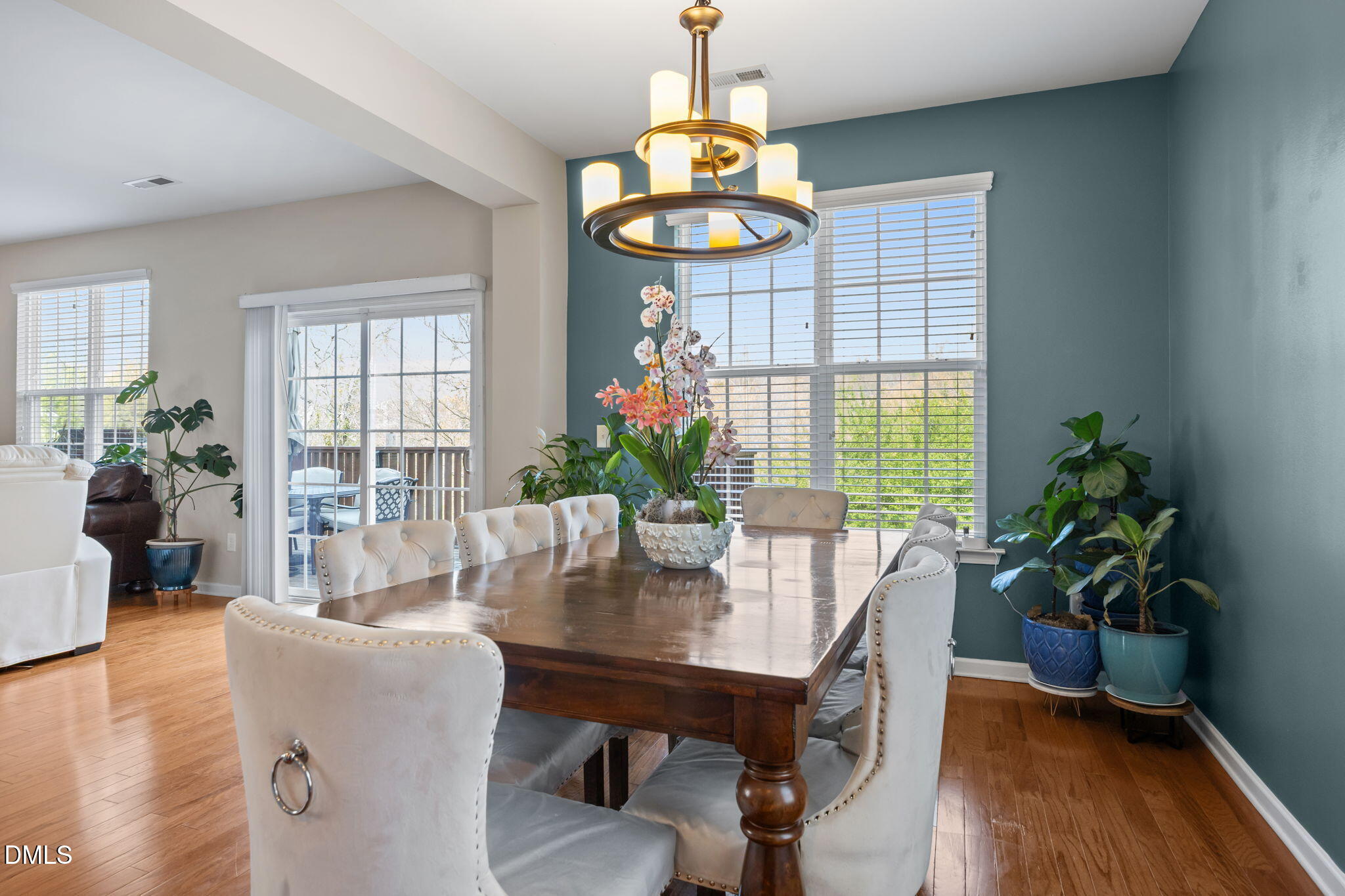 5049 Jelynn Street Raleigh, NC 27616 - Photo 7 of 33 a dining room with furniture potted plants and wooden floor