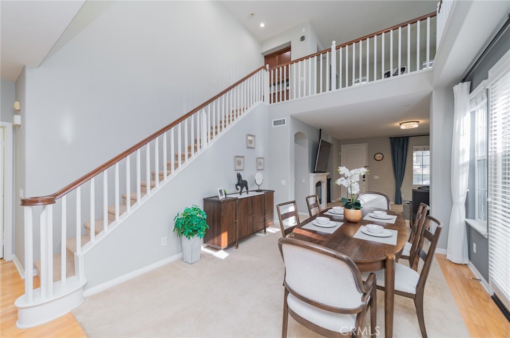 54 Shadowplay Irvine, CA 92620 - Photo 11 of 35 a dining room with furniture a rug and a chandelier