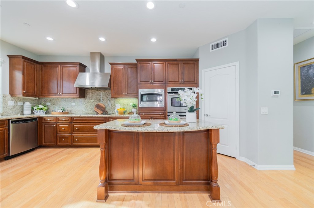 54 Shadowplay Irvine, CA 92620 - Photo 13 of 35 a kitchen with kitchen island granite countertop a sink stove and cabinets