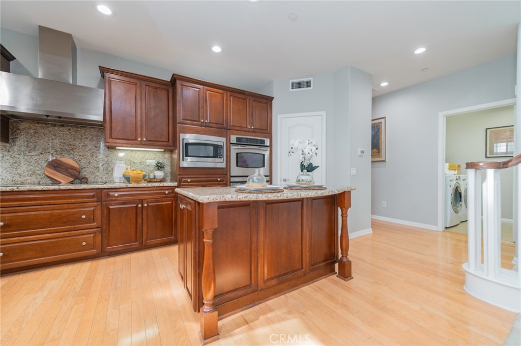 54 Shadowplay Irvine, CA 92620 - Photo 14 of 35 a kitchen with stainless steel appliances granite countertop a refrigerator and a stove top oven