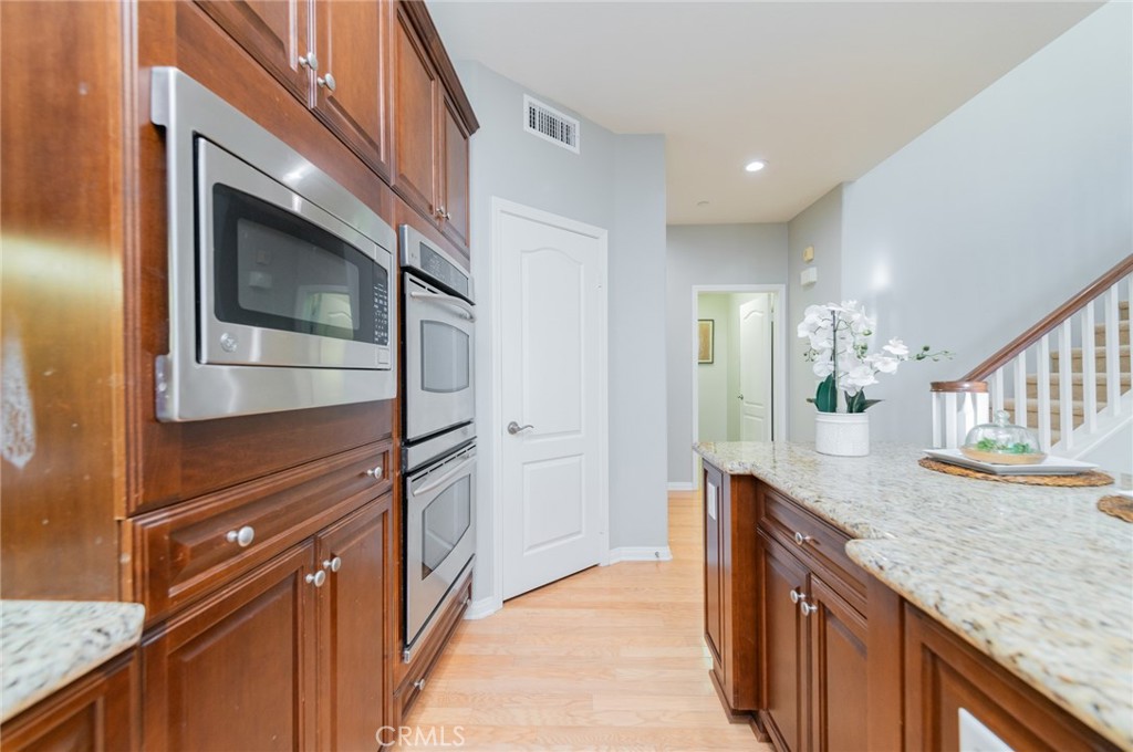 54 Shadowplay Irvine, CA 92620 - Photo 17 of 35 a kitchen with granite countertop stainless steel appliances and counter space