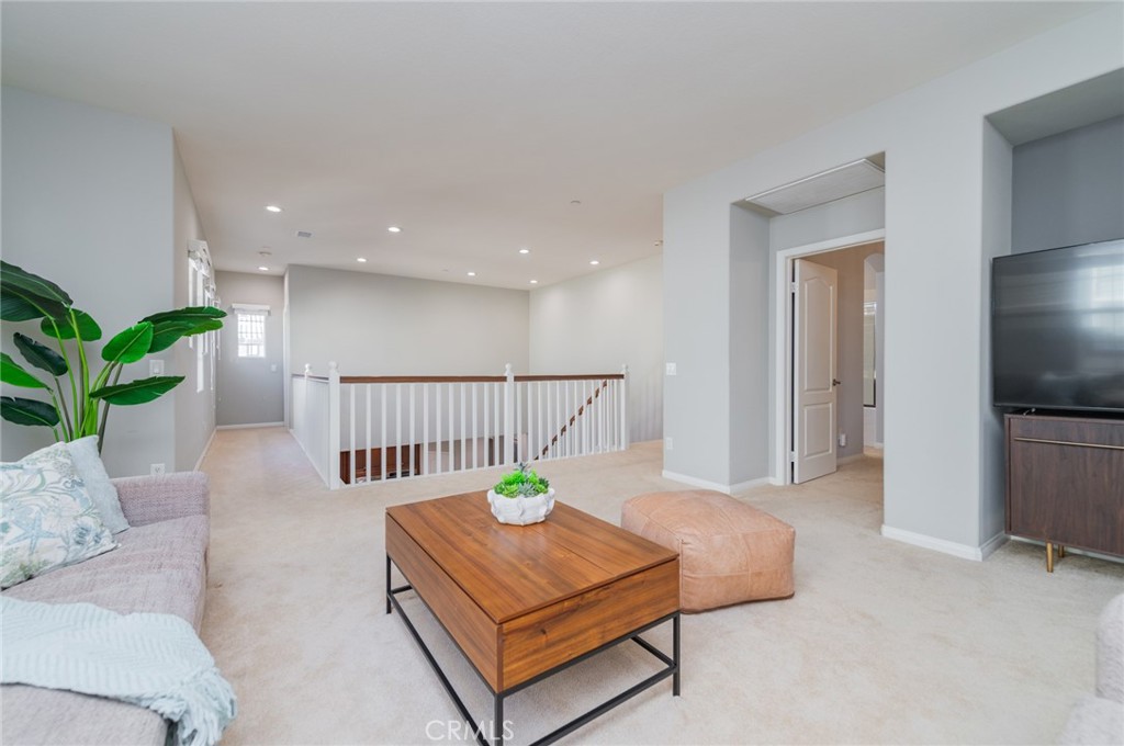 54 Shadowplay Irvine, CA 92620 - Photo 23 of 35 a living room with a bed furniture and a flat screen tv