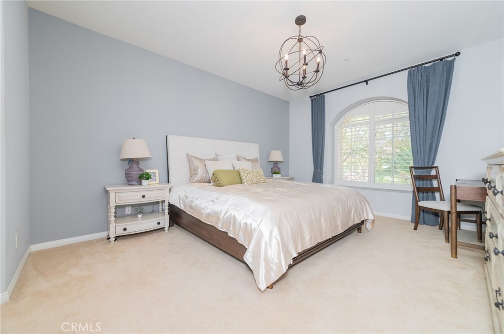 54 Shadowplay Irvine, CA 92620 - Photo 24 of 35 a spacious bedroom with a bed and a table in it