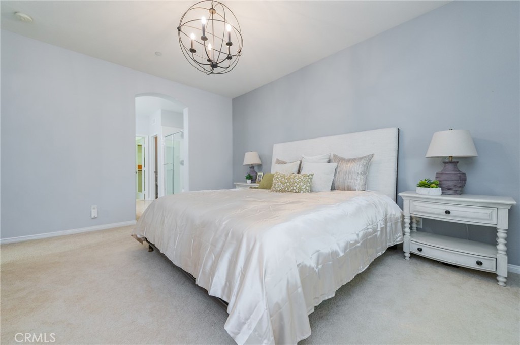 54 Shadowplay Irvine, CA 92620 - Photo 25 of 35 a bedroom with a bed and a chandelier
