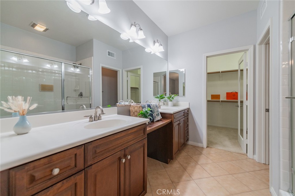 54 Shadowplay Irvine, CA 92620 - Photo 27 of 35 a spacious bathroom with a granite countertop sink and mirror
