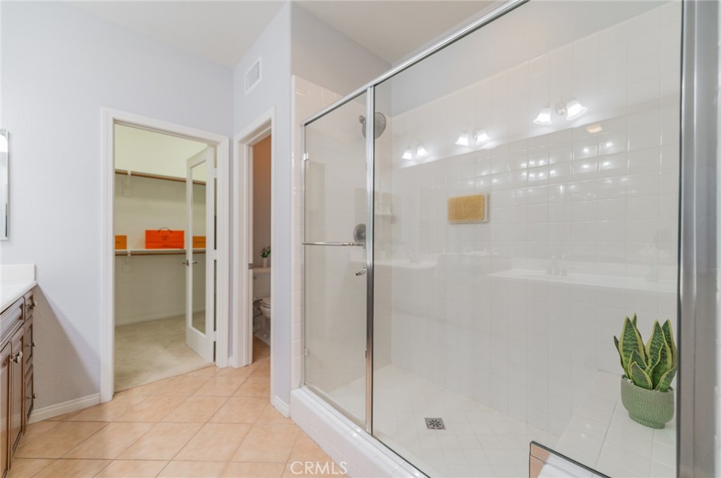 54 Shadowplay Irvine, CA 92620 - Photo 28 of 35 a bathroom with a shower and a glass door