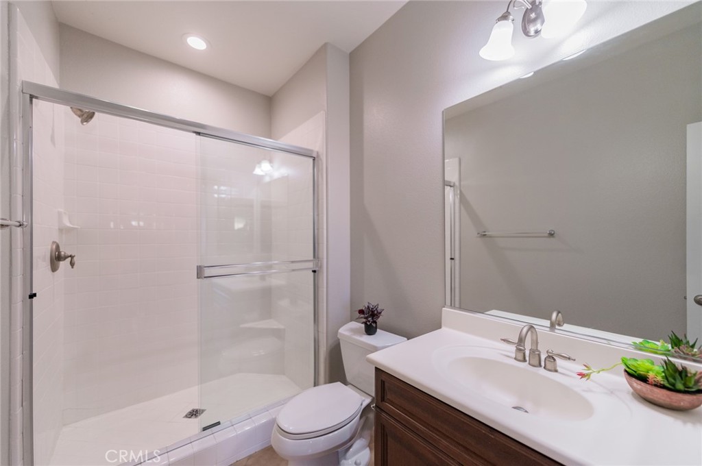 54 Shadowplay Irvine, CA 92620 - Photo 32 of 35 a bathroom with a sink a toilet and shower