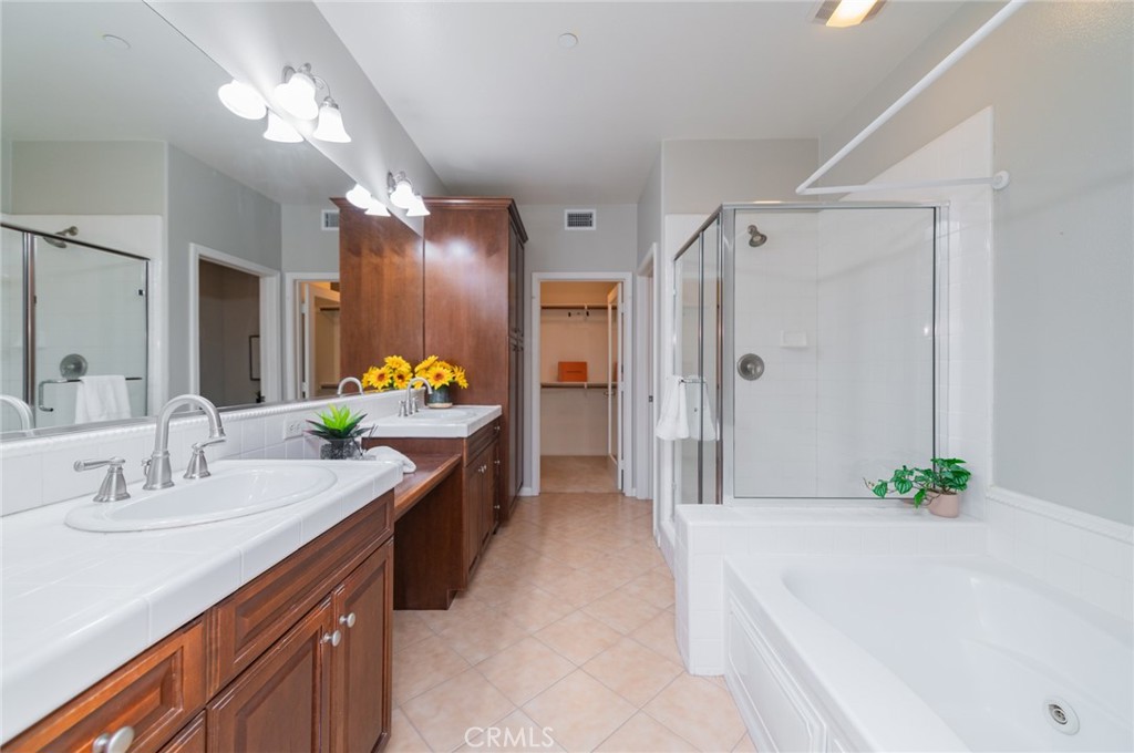 54 Shadowplay Irvine, CA 92620 - Photo 9 of 35 a spacious bathroom with a double vanity sink and a bathtub