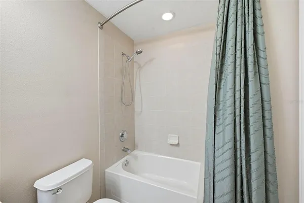 a bathroom with a bathtub and a toilet
