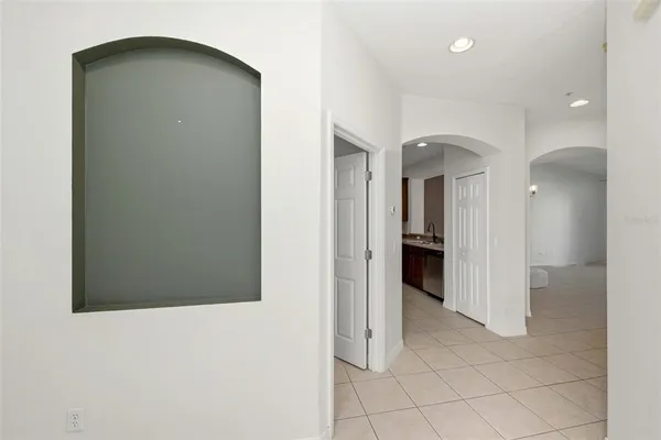 a view of a hallway to rooms