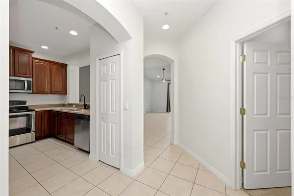 a kitchen with stainless steel appliances granite countertop a refrigerator and a stove top oven