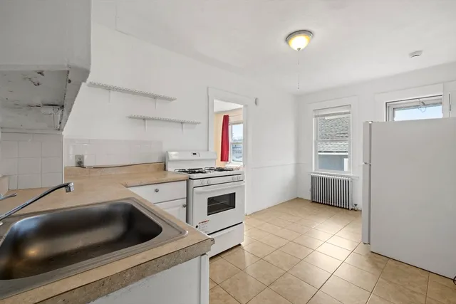 a kitchen with a stove and a sink