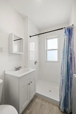 a bathroom with a sink toilet and shower