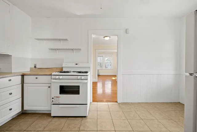 a kitchen with cabinets and white appliances