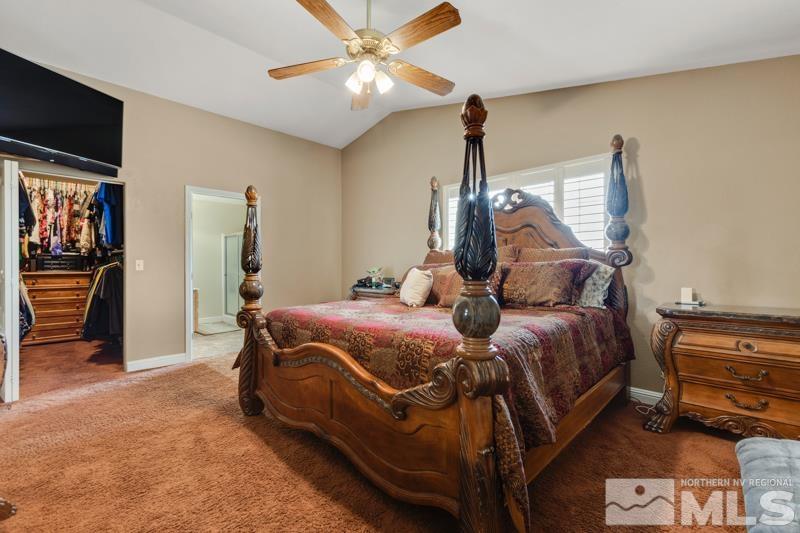 13755 Rancheros Drive Reno, NV 89521 - Photo 11 of 24 a bedroom with a bed and a chandelier