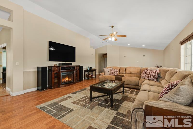13755 Rancheros Drive Reno, NV 89521 - Photo 2 of 24 a living room with furniture and a flat screen tv
