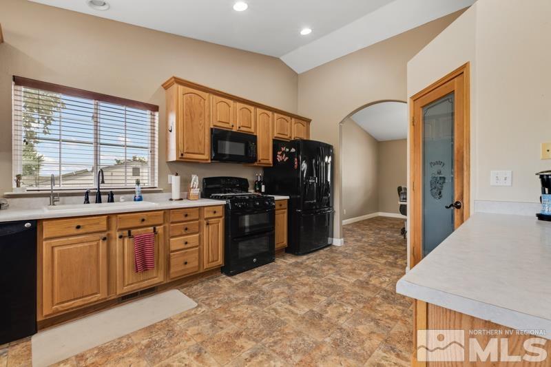 13755 Rancheros Drive Reno, NV 89521 - Photo 3 of 24 a kitchen with stainless steel appliances granite countertop a refrigerator and a stove top oven