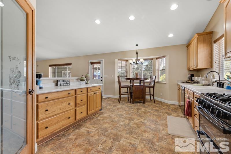 13755 Rancheros Drive Reno, NV 89521 - Photo 5 of 24 a kitchen with microwave a stove and cabinets