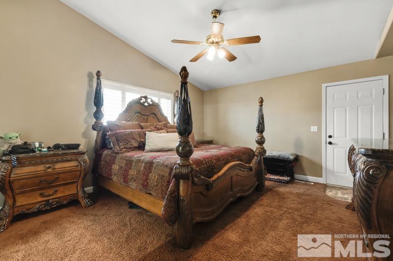 13755 Rancheros Drive Reno, NV 89521 - Photo 10 of 24 a bedroom with a bed and ceiling fan