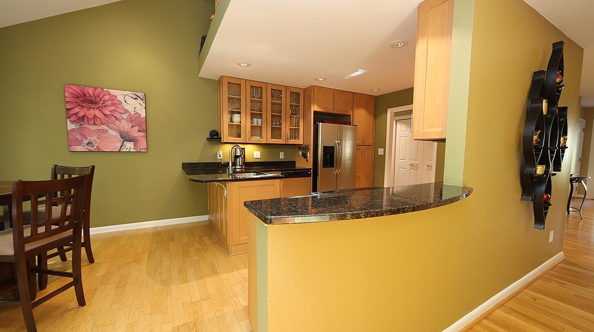 4005 Lake Springs Court Raleigh, NC 27613 - Photo 12 of 38 with granite counters and maple cabinetry Kitchen