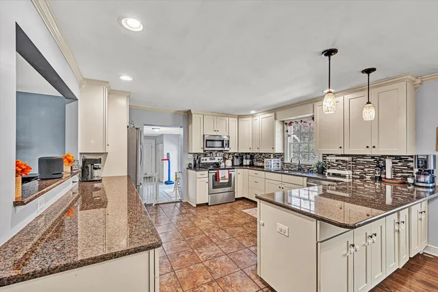 a large white kitchen with a sink and cabinets