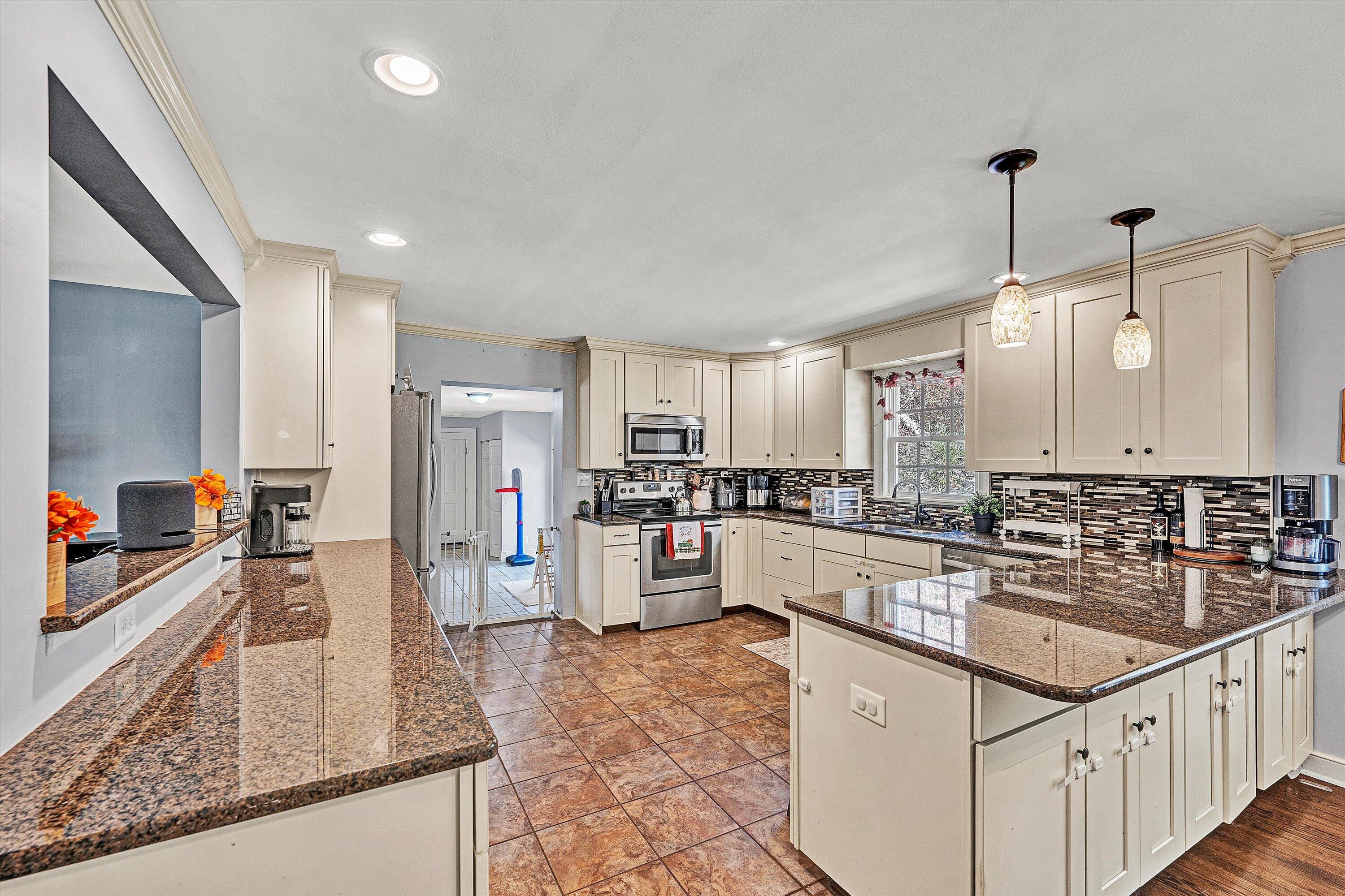 2320 Grassy Hill Road Rocky Mount, VA 24151 - Photo 14 of 57 a kitchen with counter top space cabinets stainless steel appliances a sink and a large window