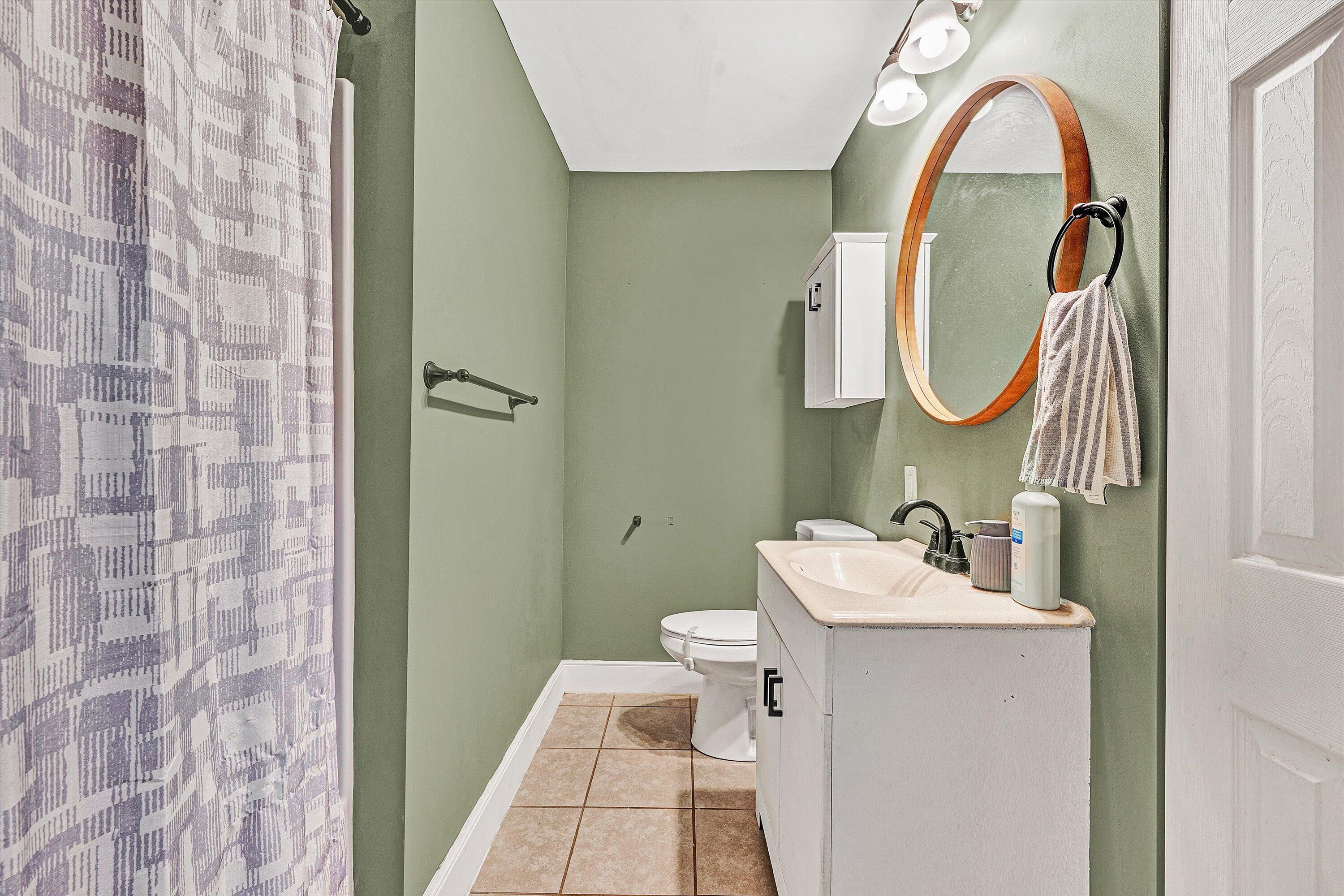 2320 Grassy Hill Road Rocky Mount, VA 24151 - Photo 26 of 57 a bathroom with a sink mirror and toilet