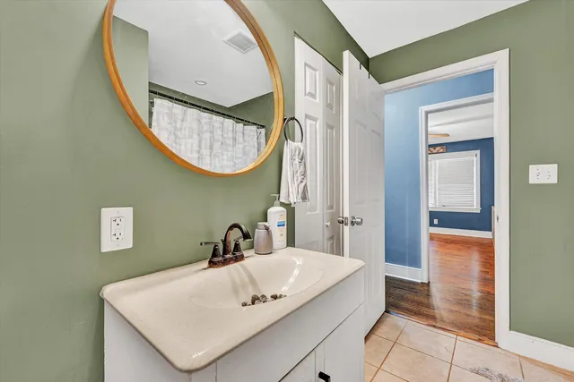 a view of a workspace with furniture and a wooden floor