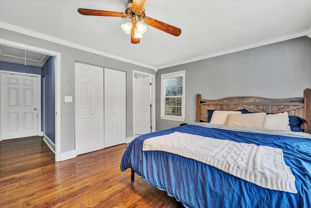 a bedroom with a large bed and a desk