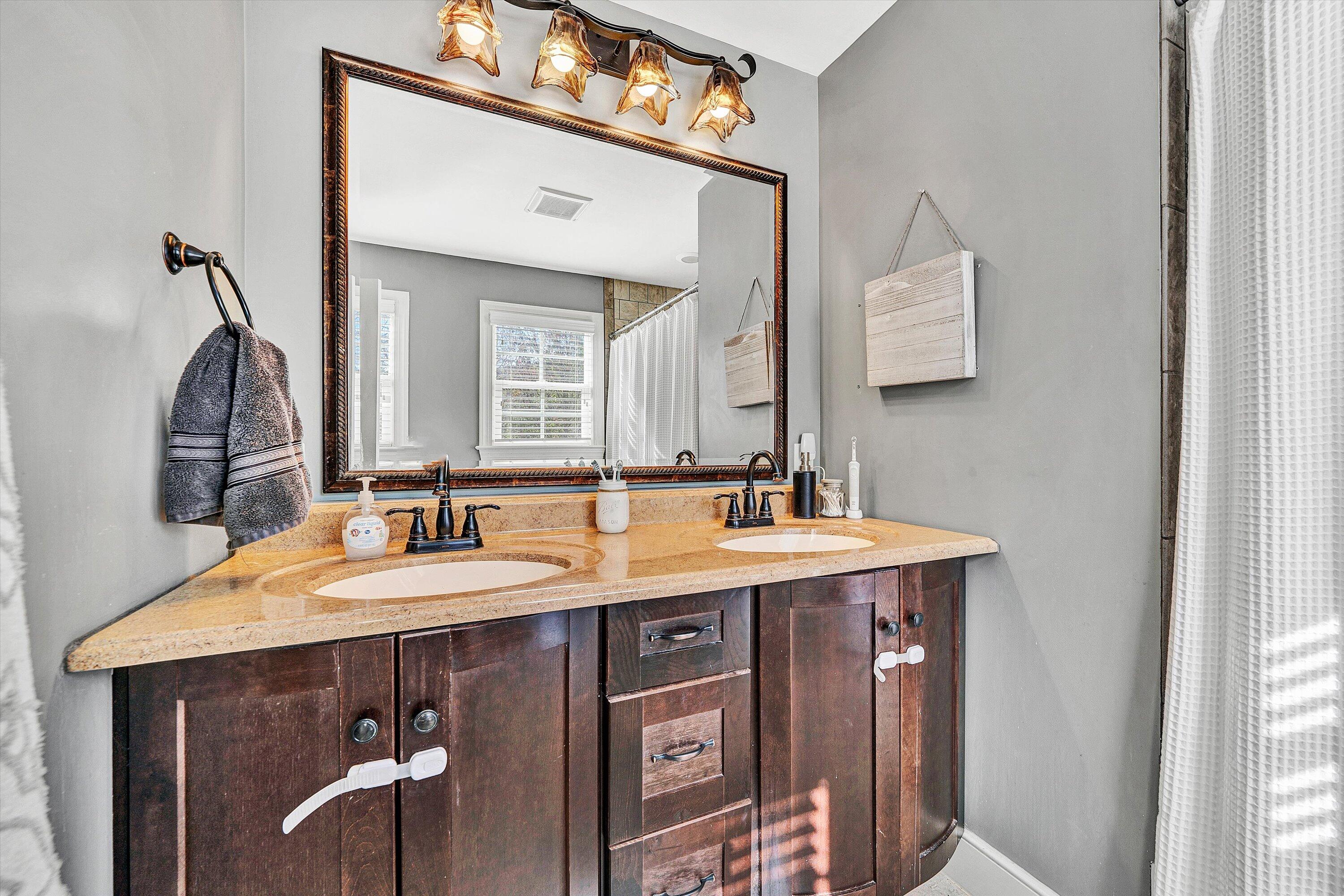 2320 Grassy Hill Road Rocky Mount, VA 24151 - Photo 33 of 57 a bathroom with a granite countertop sink a mirror and a