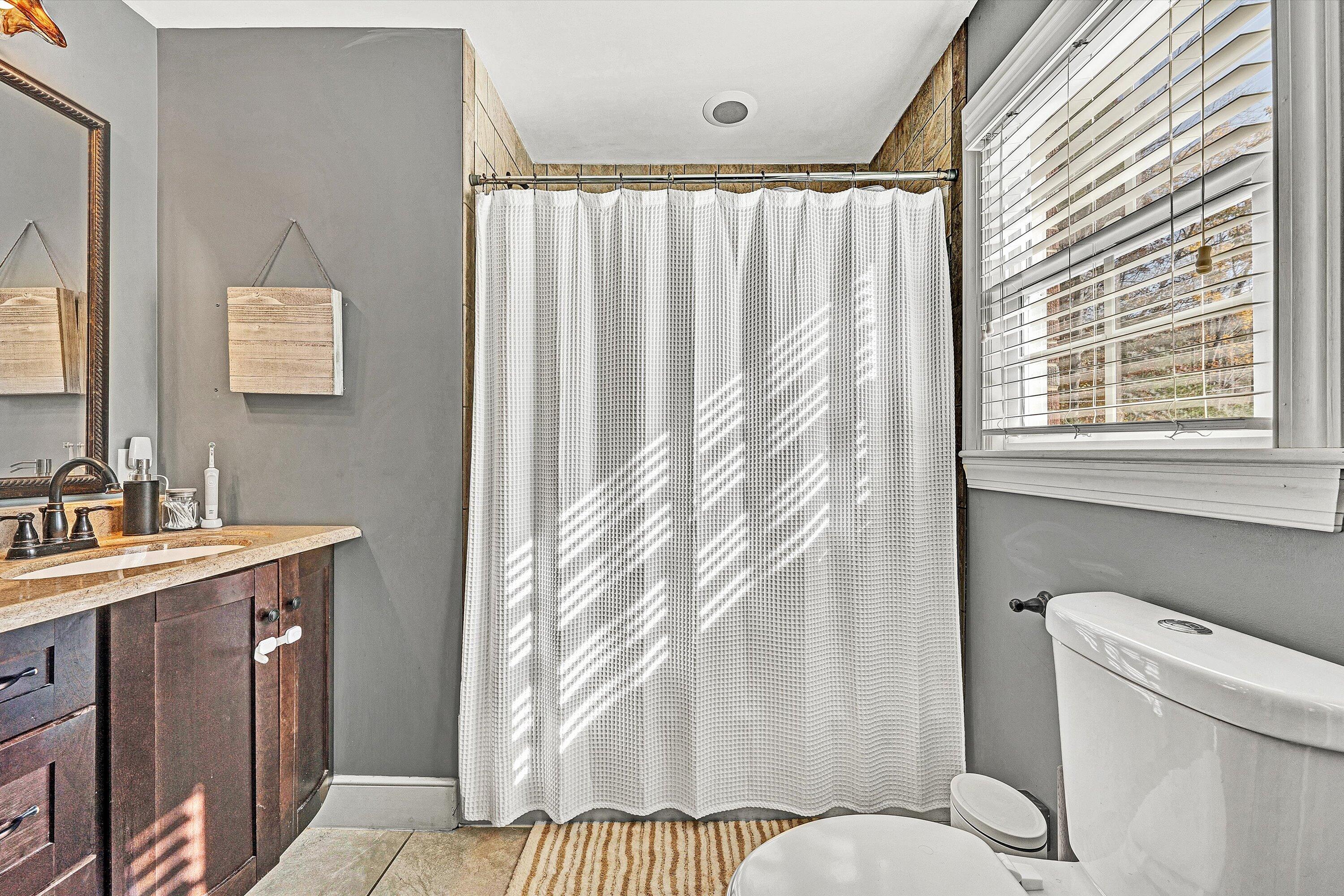 2320 Grassy Hill Road Rocky Mount, VA 24151 - Photo 34 of 57 a bathroom with a granite countertop sink and a mirror