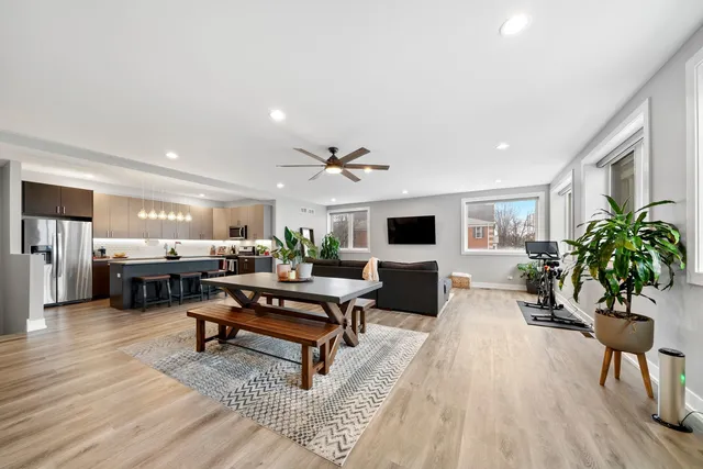 a living room with furniture a piano and a flat screen tv