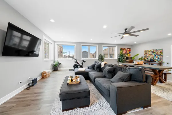 a living room with furniture kitchen view and a flat screen tv
